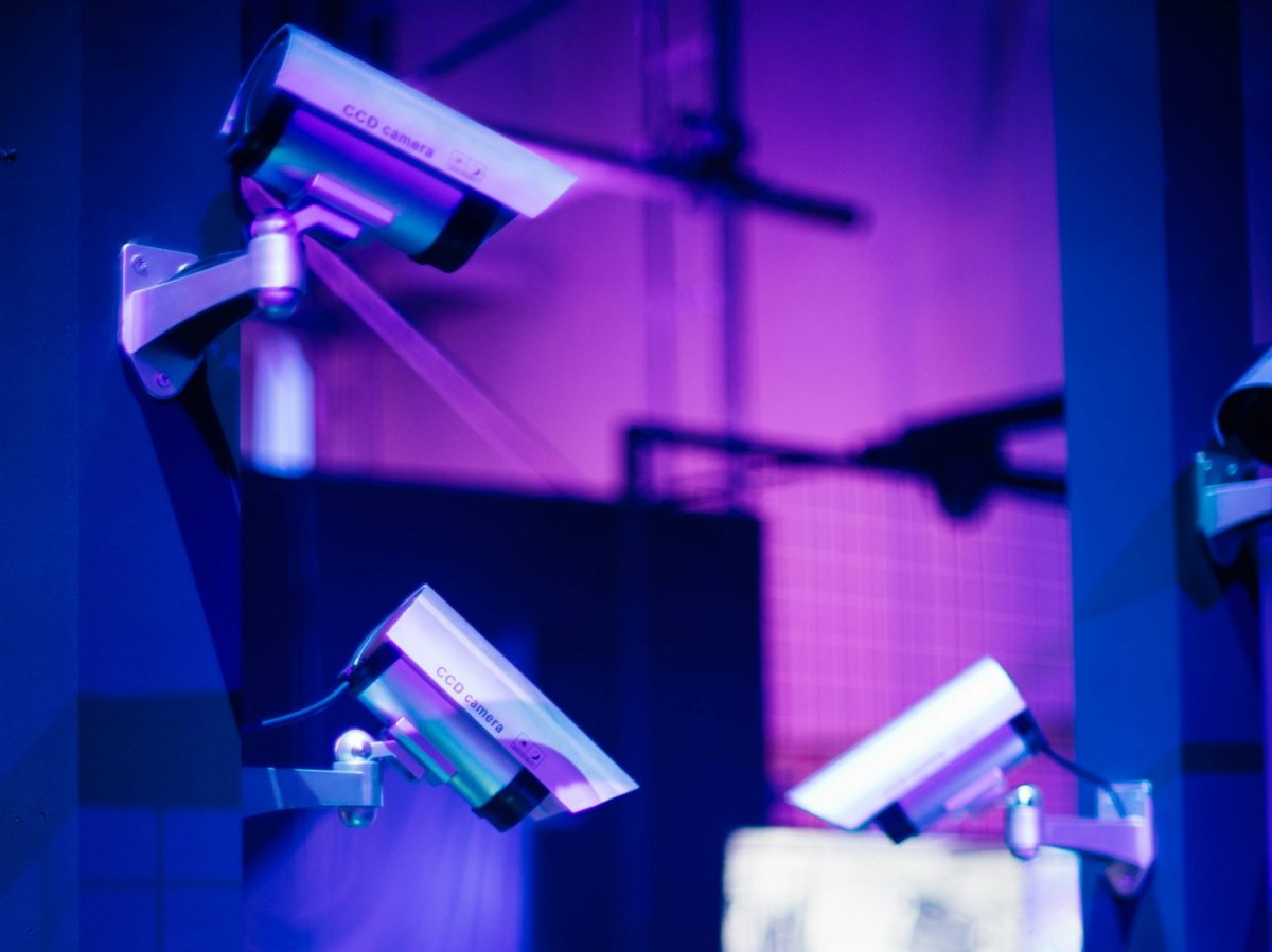 Stock image of surveillance cameras on a purple-blue background