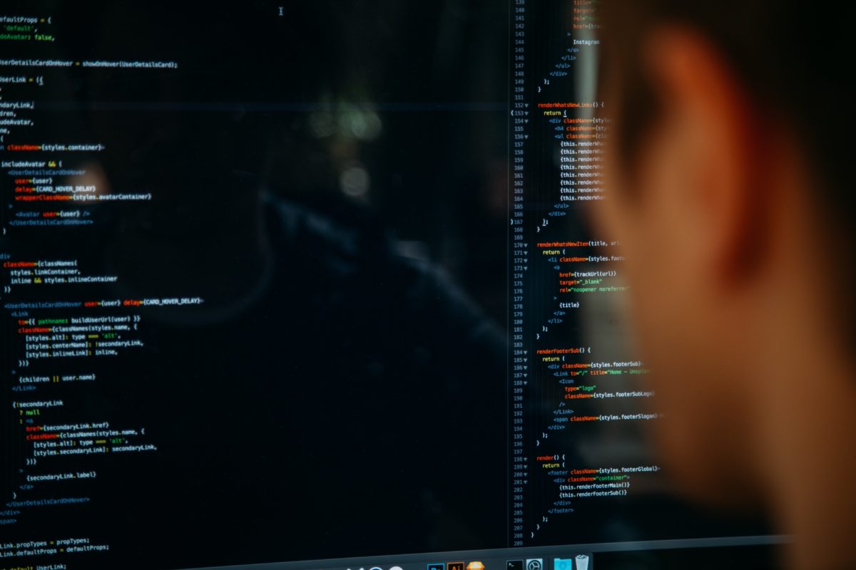 Man staring at code on a screen. Photo by Charles Deluvio on Unsplash